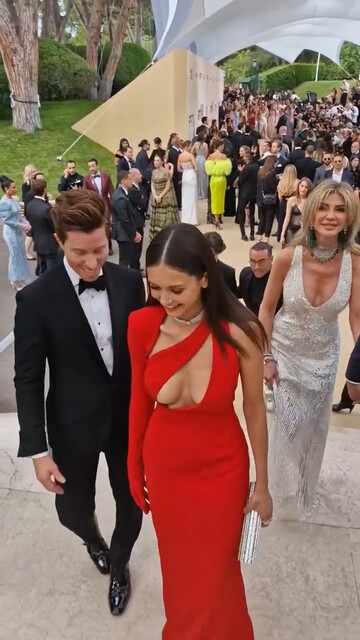 Nina Dobrev sexy - Ample cleavage in peekaboo scarlet dress (2022)