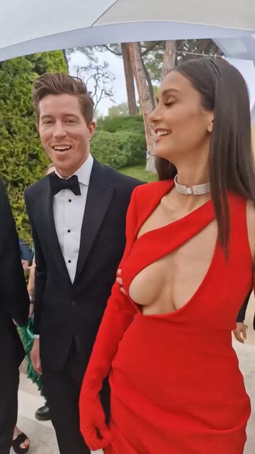 Nina Dobrev sexy - Ample cleavage in peekaboo scarlet dress (2022)